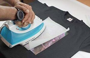 Best Iron On Transfer Paper Have you ever wanted to print your own custom designs on your t-shirt? Well, the truth is many people actually do this very thing. You may have no doubt noticed t-shirts with unique designs on people. But when you want to buy them, you will have a hard time finding them on the market. The reason is, the person did not actually buy it, but rather printed the design on his t-shirt himself. This is a great way to add a touch of flair and personality to your outfit. And you can do it on any plain t-shirt you own. To do that, you need a printer, the t-shirt you want to print, and most importantly a transfer paper. Transfer papers are unique printer papers made to transfer designs from paper to fabric. There are many types of transfer papers out there. But the easiest one to use is perhaps an iron on transfer paper. You do not need a heat press to operate it. Simply place it over your t-shirt and roll an ordinary hand iron over it. In this article, we will give you an in-depth look at some of the best iron on transfer papers available on the market. And also help you figure out which one you want for the best possible results. So, without further ado, let us dive in. What is Iron On Transfer Paper? Before we dive deeper, let us take a moment to discuss what exactly is an iron on transfer paper. Well, it is exactly what it sounds like; a transfer paper that you iron on! They are also commonly referred to as T-shirt papers. If you break it down, it is essentially a type of heat transfer paper. But instead of having to use a heat press machine, you can easily transfer the design printed on the paper to the t-shirt using a hand iron. Typically, you need a printer to use it though as you need a way to get your design printed on paper first. After that, you position the paper on the t-shirt where you want to paste the design and press down on it using your hand iron. After a couple of minutes, you will have your design printed on the t-shirt perfectly. Top 10 Best Iron On Transfer Paper Reviews Now that you know what this product is and what it does, you might be wondering what your options are. Remember, this is a very popular way to personalize your t-shirts. And these days, there are endless options out there when it comes to a transfer paper. However, not all of them give you equally great results. In the following section, we will give you our top picks for some of the finest options in the market when you are looking to buy a set of iron on transfer paper. 1. PPD Inkjet PREMIUM Iron-On White and Light Color T Shirt Transfers Paper Photo Paper Direct, or PPD for short, is a trusted name among fabric crafters. The PPD Inkjet Premium as the name suggests is their premium option for people who want to take their work to the next level. This particular iron on transfer paper is suitable for white and light-colored t-shirts, aprons, and other similar garments. With this transfer paper, you can transfer any images or texts to your garments with minimal hassle. You can use any normal scissors to cut the paper as it is quite soft. The papers are 8.5 x 11 inches in size which means each sheet will give you a lot of materials to work with. Thanks to the special formula with which it has been produced, the fabric will remain soft and flexible after you transfer the design. All you need is a simple inkjet printer by any brand and you can start using it right away. After printing the design on your textile, you can even wash it without any fear. This pack includes 10 sheets of transfer paper and comes at a very reasonable price. So, you can keep the cost of your textiles low if you are planning to use them professionally thus attracting more customers. It is also a great choice if you want to make some custom t-shirts for yourself or your loved ones. Highlighted Features • Compatible with almost any type of garments • Can be cut using regular pair of scissors • Does not require special clothing dye • It comes as a pack of 10 2. AVERY Printable Heat Transfer Paper For Dark Fabrics Avery, as a brand, really requires no introduction if you are a fan of printing labels and envelopes. When it comes to printable transfer papers for fabrics, turns out, they are one of the top brands out there. This particular option, for instance, is arguably the best iron-on transfer paper for dark shirts in the market. If you are just getting into the craft, this is one of the best choices out there for you. It comes as a pack of five giving you plenty of options to experiment with your designs. The paper is made for darker fabrics and works well with any type of garments on which you might want to print your design. However, make sure you are using cotton t-shirts as with polyester the results seem a bit lacking. With 100 percent cotton blend shirts though, the output is sublime giving you flawless colors in your image or texts. And the best part is that you can even download and use Avery templates from their official website seamlessly. This transfer paper is made for inkjet printers only. For the pack of five, the price might seem a bit high, but the quality it offers makes it pretty much worth every penny. You can easily transfer your design with a simple household iron and do not need to use a heating press to transfer design efficiently. Highlighted Features • Long-lasting colors after transfer • Suitable for 100 percent cotton fabrics • It comes as a pack of 5 • Compatible with any inkjet printers 3. PPD Inkjet PREMIUM Iron-On Dark T Shirt Transfers Paper Next up we will be looking at another option by PPD but this one is more suited for darker fabrics. If you loved the first unit on our list, then you will be glad to know that this one is pretty much the same. The only major difference between the two is the color of the fabric where you can use it. Similar to the previous option, this one is made compatible with any inkjet printer available on the market. However, if you have a laser printer only, then this might not be the ideal choice. For laser printers, we have different options on a latter portion of this article. Each of the papers in this bundle is around 8.5 inches in length and 11 inches in width. So, you pretty much get the same paper space with this one as you get with its light-colored counterpart. Thanks to its size, you can use the same sheet of paper for different prints. With this bundle, you get 10 sheets in total giving you great value for your investment. After print, your design should leave a matte finish that does not fade away with washes. It also does not require any special dyes making it a great choice for any hobbyists. Highlighted Features • It comes as a pack of 10 • 8.5” X 11” size of each sheet • Washable matte finish • Suitable for dark-toned fabrics 4. TransOurDream UPGRADED Iron on Heat Transfer Paper for T Shirts The brand TransOurDream is a great choice for small-scale fabric design businesses because of how versatile their products are. The Upgraded Iron On Heat Transfer Paper by the brand is a great choice if you plan on working with different types of textiles. That too, at an affordable price. Not only does it work with cotton fabrics but also with canvas, Lycra, elastic, mesh, and even nylon textiles. This means you do not have to stay limited to only t-shirt printing and can work on other forms of fabrics including pillowcases, caps, or even bags. This unit comes for both light and dark fabrics so make sure you pick the one that is right for your type of project. It is compatible with all inkjet papers but requires pigment or dye ink to transfer designs to the fabric effectively. The quality of the print is superb and it is durable for at least 30 washes. It is considered one of the highest value bundles out there. For a small cost, you get 20 sheets of paper, four of which are reusable Teflon papers. If you want an affordable way to get into the craft this can be a great choice. You can cut it using both regular scissors or a cutting machine. Highlighted Features • Comes as a pack of 20 • Includes four reusable Teflon papers • Compatible with inkjet printers • Compatible with a wide range of fabrics 5. NuFun Activities Inkjet Printable Iron-On Heat Transfer for Dark Fabrics Until now, the products we have reviewed were mostly focused on DIY enthusiasts and hobbyists. However, if you are planning to use iron-on heat transfer papers professionally, you need larger quantities of them. That is where the NuFun Activities Inkjet transfer paper truly shines. This might be one of the few papers on the market that is compatible with both inkjet and laser printers. The manufacturers recommend sticking to HP, Epson, or Canon if you are using inkjet printers and HP, OKI, and Ricoh if you have a laser printer at home. These papers promise the highest of qualities in design transfer with full resistance to washing. So, after any t-shirt, you design with this paper is meant to last for a respectable period. This is a must-have for both amateur designers and professionals as nobody wants a temporary design on their t-shirt. Sure, you can get this as a bundle of five sheets if you are unsure about the quality. But for people who know what they are getting, they offer excellent packs of 25 to 500 sheets at massive discounts. If you are talking about value for money, you simply cannot overlook this option. Highlighted Features • Excellent wash durability • Comes as a pack of 25 • Compatible with both inkjet and laser printer • Perfect for both personal and professional use 6. HTVRONT Iron On Transfer Paper For T Shirts The brand HTVRONT might not be the most well-known option in the market, but when it comes to quality transfer papers that work with a hand iron, they have some pretty good units to choose from. We recommend giving this particular pack a try if you want something that comes at a lower cost. It is a simple and straightforward transfer paper that is capable of capturing every bit of detail from your design. So, you can go wild with vibrant colors and intricate patterns without worry. This transfer paper will make sure that none of the details get lost in the transfer. After transferring the design to the fabric, you can stretch your t-shirt and even wash it without ruining it. The design is flexible, soft, and resistant to cracking. For such a price, the durability it offers is quite astonishing. Make sure you are only using an inkjet printer though. This bundle comes as a pack of 20 giving you enough sheets to experiment and print your favorite designs for all your clothes. Even if you are planning to start a business, 20 sheets are more than enough to get you started. It is easy to use and does not require any special skill or experience to master. Highlighted Features • Can transfer rich and vibrant colors • Comes as a pack of 20 • Suitable for white or light fabrics only • Compatible with inkjet printers 7. Frisco Craft Stencil Film / Stencil Vinyl Roll Compatible with Cricut For our next option, let us go with something different. The Frisco Craft Stencil Film is not your typical transfer paper nor does it come as individual sheets. Instead, the manufacturers give you a complete roll of vinyl stencil that can transfer designs onto your favorite t-shirts easily. The vinyl stencils come in blue color. Whether you are using white fabric or dark ones, it has the ability to make the design pop out instantly. It does not bleed colors and you do not need to worry about air bubbles while pasting it on the fabric. After print, the design you get is also quite durable and does not crack. If you are looking to buy the best iron on transfer paper for Cricut, this is the one you pick. However, without a Cricut machine, there is no point in buying this one. If you are a beginner and do not know much about such fabric crafts, we recommend staying away from this one. But if you do know your way around this craft, this can be a fantastic investment. At a small cost, you will get two whole rolls of 12” x 30’ materials that will comfortably let you go through a bulk load of projects. This is a great choice for people who regularly partake in this line of work. Highlighted Features • Compatible with Cricut, Silhouette, and other cutting machines • Includes two rolls of materials • Adhesive backing for better application • Offers great value for professionals 8. HP Iron On Transfer Paper HP is a name that is not only reputed in the electronics world but also equally as respected in the craft industry. With their iron on transfer paper, you will be able to print your favorite designs on your favorite t-shirts. It might not be enough to start a business, but it is more than enough for personal use. This transfer paper is for inkjet printers only and HP recommends using their own line of printers with this product for best results. However, we experienced no decline in quality even when used with other brands of printers. As long as your printer is inkjet variant, you should be fine using this transfer paper. Each sheet of paper comes with a size of 8.5 X 11 inches giving you plenty of paper space. You can use it with a wide range of fabrics to get your vibrant and colorful images and text printed on it. It also works great for designing caps, bags, and other small items. This pack includes 12 sheets of paper which should be enough for personalizing a couple of your favorite items. For business, you might need to buy a couple of these bundles which might not be the most economically wise decision. However, for casual use, it can be a pretty good investment. Highlighted Features • Comes as a pack of 12 • Can transfer colored designs flawlessly • Compatible with inkjet printers • Each sheet is 8.5 inches in length and 11 inches in width 9. Jolee's Boutique Easy Image Iron-on Transfer Paper The Jolee’s Boutique Easy Image Iron on Transfer Paper might be the first pick for thousands of users. This unit by EK Success Brand gathered a lot of popularity because of its ease of use, and how flawlessly it can transfer the print to your fabric. If you have never used it before, now is a good time to get one for yourself. You need to use an inkjet printer to print on this transfer paper. Once you print it, you can simply iron it onto your fabric of choice. For best results, you should use it on cotton shirts. But it can still be used perfectly well with other surfaces and materials without any noticeable decline in quality. One thing to keep in mind though; this particular option is suiatable only for darker fabric colors. For lighter fabrics, you want to look for a model specially designed for that type of material. After printing your image on the shirt, you can wash it without any fear of damaging the design. With your purchase, you only get five sheets of paper. Considering the price it asks, it does seem like a bit of a letdown especially if you want to use it professionally. However, if you want to print a couple of t-shirts with your own design, then you can go with this option in a heartbeat. Highlighted Features • Comes as a pack of five • Suitable for darker fabrics • Compatible with inkjet printer • Durable and colorful print results 10. Epson Iron-on Cool Peel Transfer Let us wrap up this list of reviews with another name that is quite well-known especially among those who regularly use a printer. This time, we will be looking at an entry by Epson. This Iron-on Cool Peel Transfer paper has many features that make it worthwhile if you are looking for the best iron on transfer paper for t-shirts. Not only is it compatible with cotton t-shirts, but is also suitable for other fabric materials. This makes it a great choice for designing products like aprons, tote bags, pillowcases, etc. Whether you are transferring texts or images, you should find no lacking in quality. The thing that we love most about this unit is how easy it is to peel off after cooling. With cheap transfer papers, there are instances when the design would come right off with peeling. Though it is priced so low, we never faced such issues with this product. This is advertised as a starter bundle which is why it comes with 10 sheets of paper. The simple design and user-friendly nature of this bundle make it a great choice for any beginner. And considering the laughable price of the unit, there is no reason to at least try it out to see if you like it. Highlighted Features • Comes as a pack of 10 • Perfect choice for beginners • Easy to peel after cooling • Suitable for multiple fabric types Best Iron On Transfer Paper Buying Guide Getting good transfer papers is the first step to starting a custom t-shirt business. But many people use it to make t-shirts for personal use too. In either case, you want to make sure that you are getting some high-quality transfer papers. Otherwise, the finished output might not be as good as you wanted. Our list of products should already give you some pretty great options. But which one do you choose? Well, despite the simplistic nature of iron on transfer papers, there are actually many small details you need to think about when you buy one for yourself. You need to think about factors like the type of printer you use or the color of the fabric you want to print before settling on a specific product. Otherwise, you might end up with a result that does not fully satisfy you. Since the whole point of printing custom designs on a t-shirt is self-satisfaction, that is the last thing you want. To that end, here are a few things to know and consider when you are deciding on an iron on paper. 1. Compatibility The first thing you need to check is whether the transfer paper is suitable for the type of fabric or surface you are working with. When it comes to textile, typically, iron on photo transfer paper is compatible with cotton and polyester. But there are other options out there for different surfaces. If you want to transfer your image or text to surfaces like wood, glass, or leather, you need to go with specialized papers for those specific surfaces. These days, there are a few different options available for people with these requirements. All you have to do is make sure you are buying the paper compatible with your needs. 2. Fabric Color If you are printing exclusively fabrics, then take some time to consider the color of the fabrics where you want to transfer the print. You will have different options depending on whether you are printing on a piece of light-colored fabric or a dark one. You do not want to overlook this critical detail. Using an iron on heat transfer paper that is made for white fabrics on a dark surface may cause the image to look pixelated and underwhelming. If you care about the looks of your textile after printing, make sure you are investing in a transfer paper for your specific fabric texture. 3. Quantity Everybody wants the best value when buying a new product. Since transfer papers come in a bundle, you want to make sure you are getting enough sheets of paper for your specific needs. Typically, you can buy this product in packs of ten or twenty. But you can also order more quantities if you are printing in a professional capacity. If you are just trying out this craft though, we recommend going with at least a pack of 10. This would give you enough papers to experiment and figure out the best possible output from your prints. And once you become more comfortable with this type of project, you can invest in higher quantities for better value. 4. Size And Shape Iron on transfer papers come in different sizes. Some units come with a length of 12 inches and a width of 15 inches whereas you might get only 8.5 inches length and 12 inches width with some bundles. This might not seem like a big deal to many, but to get the most out of your purchase, this is an important consideration. Remember, transfer papers can be cut down to match the size of the print. This means you will be able to use one portion of the paper for one project, saving the rest for later. Going with a larger and wider transfer paper often gives better value to the consumer. 5. Printer Compatibility Before you can use the transfer paper on your fabric, you need to print the design using a printer. That is why you need to know whether you have a laser or an inkjet printer at home. Usually, transfer papers are only compatible with one type of printer, not both. If you check our list of reviews, you will find options for both types of printers. We have showcased some great laser iron on transfer papers if you have a laser printer at home. With inkjet printers, you have a bit more flexibility as most modern papers are designed for inkjet printers. 6. Ink Compatibility You also need to think about the ink that your printer uses and whether it is compatible with the transfer paper that you are planning to buy. Not all papers work equally well with the standard ink that you use for printing documents. Some even require special fabric dyes to print quality images. If you are working as a hobbyist or a small-scale businessman, we would suggest getting transfer papers that work with regular inks instead of dyes. That way, you do not have to invest in an industry-grade printer and can work with the basic inkjet or laser printer you have at home. 7. Print Durability What is the point of printing your own design on a t-shirt, if it starts fading after a couple of wash? No point at all! With high-quality transfer paper, you should be able to wash it immediately after printing. The quality of the print should not take a hit if you wash it. Unfortunately, there is no easy way to tell whether the print will come off after wash or not just by looking at the transfer paper. That is why before committing to a specific option try to look at other people’s experience with that specific transfer paper. If there are any potential red flags you need to know about, you will find them instantly. 8. Ease Of Use Some transfer papers make it extremely easy for beginners to work with them. If you are relatively new to this line of work, consider investing in a unit that does not require any extra skill to use. The simpler the process, the better the experience for a new user. Unless you are using cloth dyes and industrial-grade printers, there is no point in getting transfer papers that require special dyes. You want to go with a simple option that works with regular ink. Also, consider whether you need any special cutting machine to cut the paper. For best results, go with papers that you can cut with a normal pair of scissors. 9. Versatility By versatility, we mean a couple of things when it comes to transfer papers. Some options on the market allow you to transfer designs not only to fabrics but also to a wide range of other surfaces including glass or leather. In addition, some papers are compatible with both inkjet and laser printers. Though this might not be a critical factor for everyone if you are someone who changes gears frequently it might be worth thinking about. That way, when you upgrade your printer, you do not have to invest in a new bundle of iron on transfer papers making your previous investments obsolete. 10. Price It might be tempting to go with cheap iron on transfers for t-shirts, but that is rarely the best idea. The quality of the print that you get using low-end papers is not worth the hassle of printing your own design. And if you are printing fabrics professionally, using low-quality, cheap papers damages your reputation. However, that does not mean you should go with the most expensive option on the market. There are some great options in the affordable range that give you excellent color output. In fact, a lot of the products that we showcased are inexpensive and offer superior quality. How To Print On A Transfer Paper? With all the information you already have gathered from above, you should have no trouble buying a high-quality iron on transfer paper. However, getting the print that you desire is a whole other thing. If you are a complete beginner, printing designs using transfer papers might be an entirely new concept for you. To help you learn how to use it efficiently, we have created a detailed guideline on how to print on a transfer paper efficiently. 1. Creating the Image The first step to creating your custom t-shirt design is to create the design itself. If you have worked with any image editing software, you should have no trouble figuring this step out by yourself. However, if you are completely new to this, we recommend choosing a free software like GIMP or PhotoScape and watching a few tutorials on the internet. 2. Printing the Image Once you have the designed image that you want to apply to your t-shirt, you need to print it on the transfer paper first. This step is quite easy and effortless. Simply place the transfer paper on the appropriate slot of the printer and press print. One thing to note before you print, however, is that you need to flip the image that you are printing on the transfer paper. The reason is that after applying the image on the t-shirt, it will flip back to its original design 3. Pasting the Image The final step to printing using your iron on transfer paper is to paste the printed image on your desired t-shirt. Place the shirt on a flat surface and stretch it out to remove any wrinkles. You want to place cardboard or a block of wood under the part of the fabric where you want to paste the design. This means if your goal is to print on the top side of the shirt, place a block of wood inside the shirt separating the top and the bottom. Then position the transfer paper with the image facing towards the shirt. Turn on your hand iron and switch to high heat settings. Then carefully go over the entire area of the transfer paper a couple of times. Make sure you are applying heat evenly across the entire surface. It should not take more than two or three minutes for the design to be pasted perfectly. After it is done, peel off the sticker on top of the design and you are done. Frequently Asked Questions 1. Are there different types of transfer papers? Yes, there are many different types of transfer papers out there. In fact, transfer papers can also vary depending on the type and color of fabrics you are working with. 2. Can I use any heat transfer papers with a hot iron? No. Just because you have heat transfer paper, does not necessarily mean that it will work with a hot iron. You might need a heat press machine for that. That is why it is important to check if your transfer paper is compatible with hand iron before you buy it. 3. What type of finish do I get using iron on transfer papers? Typically, most irons on transfer papers leave a matte finish on the design. However, that can vary depending on the brand and the product you are using. If you want a glossy finish, there are several units out there that give you that type of finish. 4. Can I wash t-shirts designed using iron on transfer papers? Yes. Iron on transfer paper designs can last through at least twenty to thirty washes without fading. 5. Which type of printer is best for iron on transfer papers? These days, you can find iron on transfer papers for both inkjet and laser printers. However, we recommend using an inkjet printer since the ink settles down better on the fabric with this type of printer. Final Thoughts Learning how to use an iron on transfer paper will let you experiment and print custom designs on your favorite t-shirts. The quality and durability of the print will be superb as long as you invest in high-quality papers and follow the printing process to the tee. We hope our article on the best iron on transfer paper could help you out with all the information you need to start printing your own t-shirts like a pro.