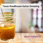 Photo of glass jar full of Italian Dressing on a wood table