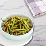 air fryer green beans in a white bowl on a marble counter top