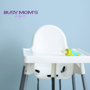 Photo of a white high chair that is empty.