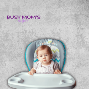 baby in high chair on a gray backdrop